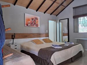 a bedroom with two beds with towels on them at Pousada Juriti - Eco Hotel in São Roque +194 photos