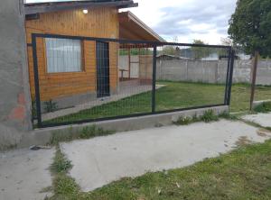 a gate to a backyard with a fence at Cabaña San Francisco in Cholila