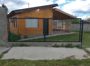 a gate in front of a small house at Cabaña San Francisco in Cholila