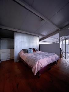 a bedroom with a large bed in a room at Casa Sol de Enero in Malargüe