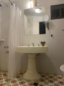 a bathroom with a sink and a mirror at Casa Sol de Enero in Malargüe