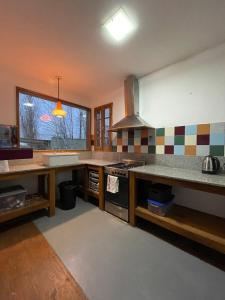 a kitchen with a sink and a stove top oven at Casa Sol de Enero in Malargüe