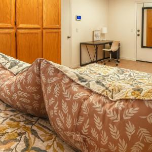 a large bed in a room with a desk at Silver Sands Den in Hemet