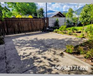 eine Auffahrt mit einem Zaun im Hof in der Unterkunft Cabaña pasaje las rosas in Pucón