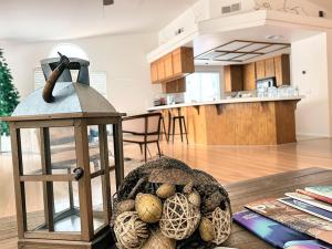 a lantern and acorns on a table in a living room at Silver Sands Den in Hemet +38 photos