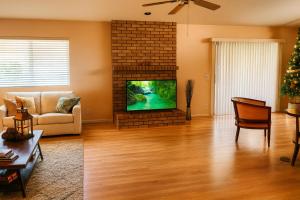 a living room with a television and a fireplace at Silver Sands Den in Hemet