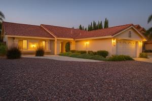 a large house with a garage at night at Silver Sands Den in Hemet