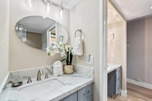 a bathroom with a sink and a mirror at Mahana 1202 · MA 1202 OceanFront Penthouse Studio in Kaanapali in Kahana +43 photos