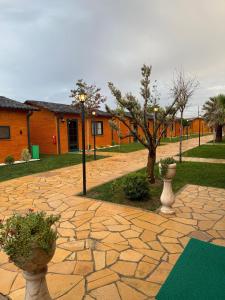 a stone walkway with vases and trees and a building at Some Hotel Antakya in Hatay