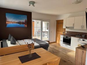 费尔兹姆斯Kleinbergsonne的一间带一张床的客厅和一间带桌子的厨房