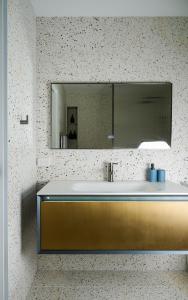 a bathroom with a sink and a mirror at Treetop Retreat with Private Spa Mountain Views in Warburton +33 photos