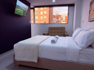 Un pat sau paturi într-o cameră la Duitama Loft