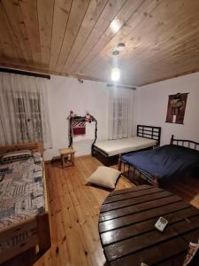 a room with two beds and a wooden floor at Σπίτι στο χωριό in Filýra