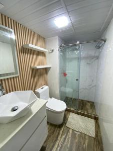 a bathroom with a toilet and a glass shower at Apartamento Exclusivo Av Principal LECHERIA in El Morro de Barcelona
