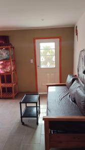 a living room with a bed and a table at Positiva 3 in Mar de Ajó