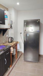 a kitchen with a stainless steel refrigerator in a kitchen at Positiva 3 in Mar de Ajó
