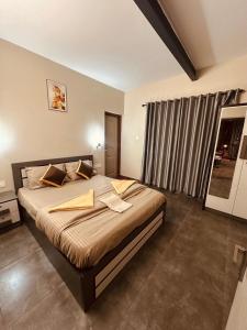 a bedroom with a large bed in a room at SURAAS Homestay Vythiri in Vythiri