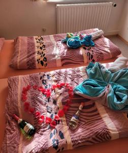 a bed with two beds with bottles and a heart on it at FEWO RENKEN in Trassenheide