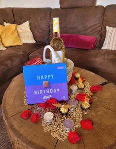 a bottle of wine sitting on top of a coffee table at FEWO RENKEN in Trassenheide