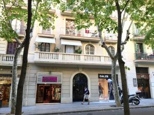 a person walking down a street in front of a building at Gaudi SDB in Barcelona