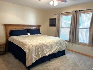 a bedroom with a large bed with blue pillows at North Country Retreat in Saint Ignace
