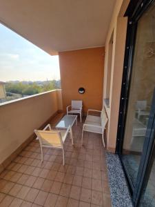 a balcony with chairs and tables on a building at Casa di Mike in Canegrate