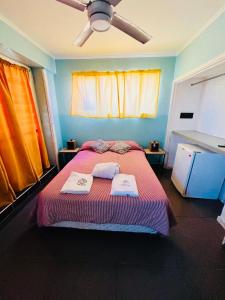 a bedroom with a bed with two towels on it at hotel los ACANTILADOS in Mar del Plata +33 photos