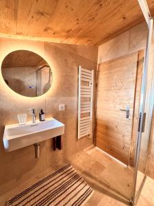 a bathroom with a sink and a mirror at Le Raidillon Verbier in Verbier +12 photos