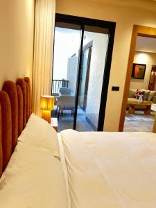 a bedroom with a bed and a view of a living room at Appartement CFC in Casablanca