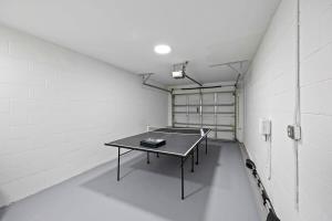 a room with a ping pong table in it at Stylish Townhome w Hot Tub 5 Min Walk to Beach in Cape Canaveral