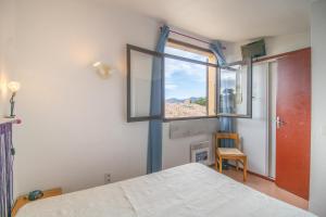 Ένα ή περισσότερα κρεβάτια σε δωμάτιο στο Location Porticcio