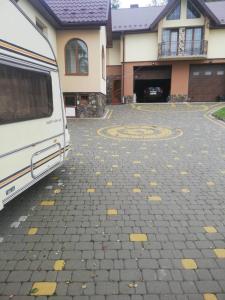 a white van parked in front of a house at Будинок у Олени in Pochayiv