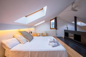 a bedroom with a large bed and a fireplace at Tierra de Biescas in Biescas +177 photos