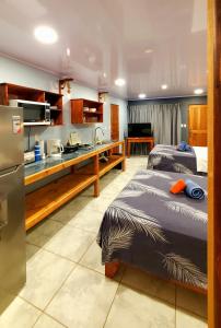 2 camas en una habitación con cocina en Willy's Fish Camp Hillside Sea View Rooms, en Drake