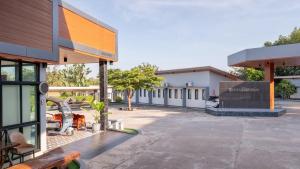 a building with a parking lot in front of it at Thailand Laos Border Superior Room in Ban Na Ko