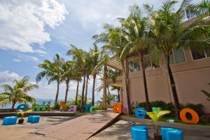 a resort with palm trees and a playground at Ellis Ecotel in Legazpi