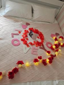 a bed with red flowers and lights on it at Romantic Winter Package , K-Culture Experience Itaewon 7min,2F Korean Culture Zone ,Terrace , K-Ramen Challenge in Seoul