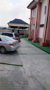 a car parked in a parking lot next to a house at Casamia in Ogba +5 photos