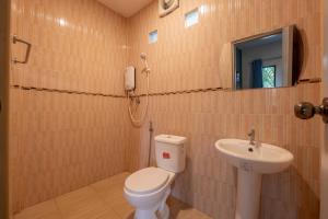 a bathroom with a toilet and a sink at Thailand Laos Border Superior Room in Ban Na Ko