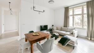a living room with a table and a couch at Designer Touch 2-bedroom in Picturesque Area in Golčŭv Jeníkov