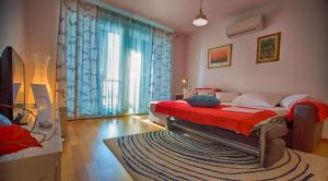 een slaapkamer met een bed en een groot raam bij Apartment Belavista in Split