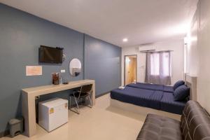 a bedroom with a bed and a desk and a tv at Thailand Laos Border Superior Room in Ban Na Ko +59 photos
