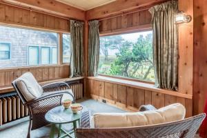 a room with a table and chairs and a window at The Tides in Seaside +37 photos