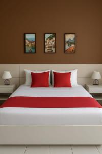 a bedroom with a large white bed with red pillows at Residencial New Stilo-Falésia in Canoa Quebrada +20 photos