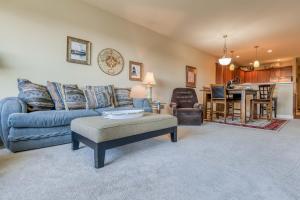 a living room with a blue couch and a table at Rivers Edge at Bridgeport in Seaside +28 photos