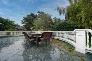 une table et des chaises à côté d'une clôture blanche dans l'établissement Pacific Way Villa, à Gearhart