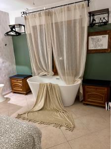 a bathroom with a tub and a shower curtain at Casa Halcón in Jávea +91 photos