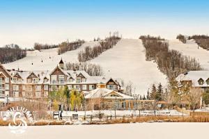 a resort with snow on a hill with a ski slope at Slopeside Loft at North Creek Resort in Blue Mountains