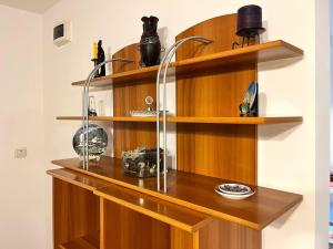 a room with wooden shelves on a wall at Memory Lane Cottage – Posada in Comarnic +33 photos