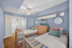 a bedroom with two beds and a ceiling fan at PW1369: 1369 Pelican Watch in Seabrook Island +53 photos